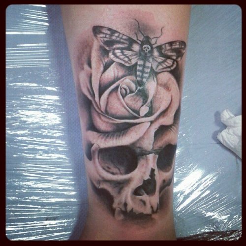 Grey Ink Skull And Moth Tattoo On Leg
