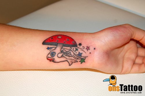 Tiny Colored Stars And Mushroom Tattoo On Left Wrist