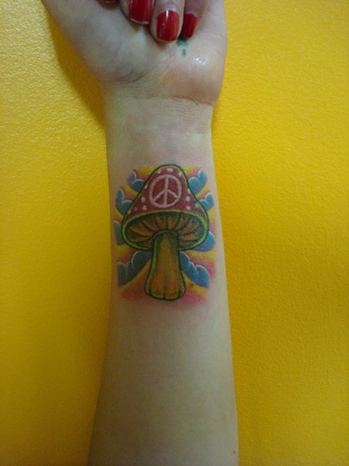 Peace Mushroom Tattoo On Girl Left Forearm