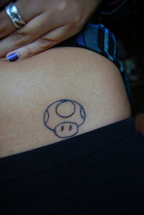 Girl Showing Her Mushroom Outline Tattoo On Hip