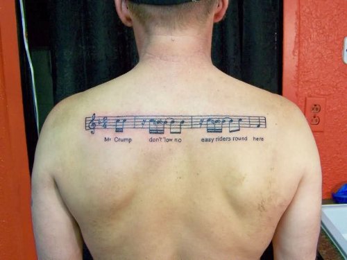Music Tattoo On Man Upperback