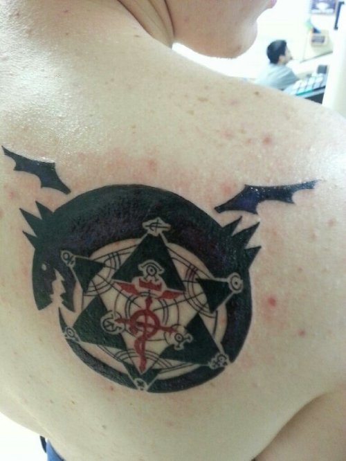 Star And Ouroboros Tattoo On Right Back Shoulder