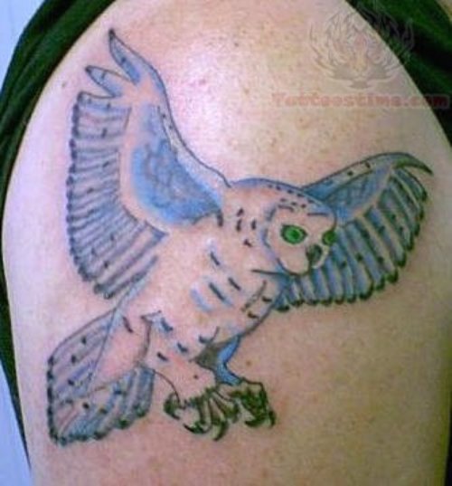 Blue Ink Flying Owl Tattoo On Shoulder