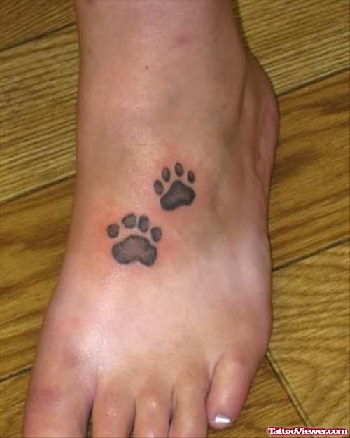 Realistic Paw Prints Tattoo on a Foot
