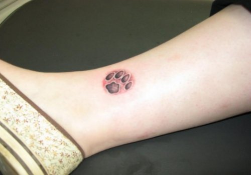 Small Grey Paw Tattoo On Side Leg