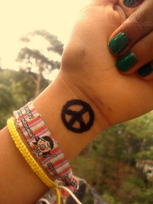 Peace Sign Black Ink Tattoo On Girl Wrist