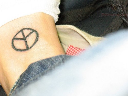 Black Ink Peace Tattoo On Foot