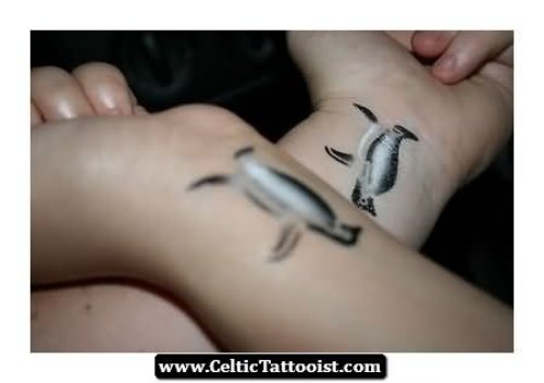 Water Ink Penguin Tattoos On Wrists
