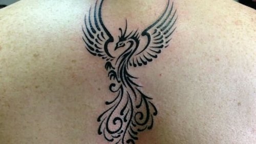 Black Ink Tribal Phoenix Tattoo On Upperback