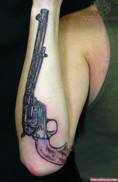 Pistol Tattoo On Back Arm