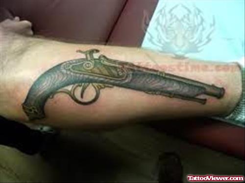 Large Pistol Tattoo On Arm