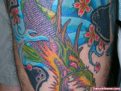 Colored Japanese Flowers And Dragon Thigh Tattoo