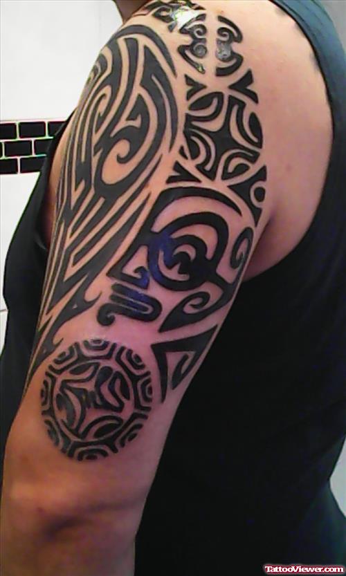 Black Ink Tribal Tattoo On Left Sleeve