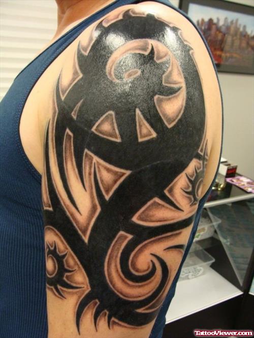 Amazing Black Ink Tribal Tattoo On Left Half Sleeve