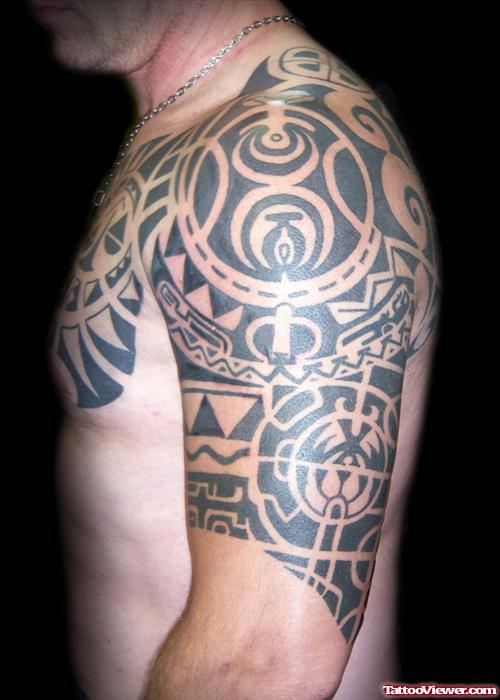 Black Ink Maori Tribal Tattoo On Left Half Sleeve