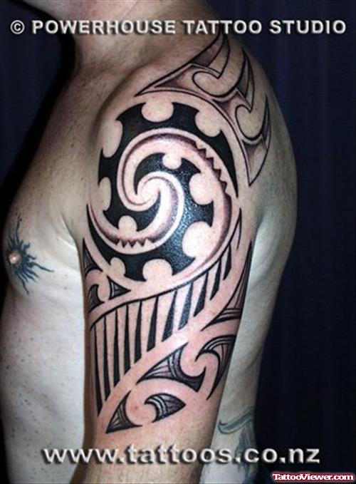 Black Ink Tribal Polynesian Tattoo On Left Shoulder