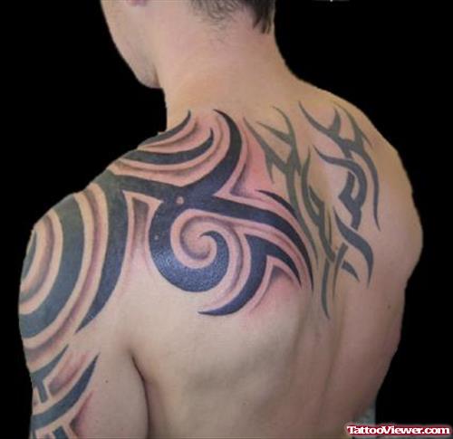 Tribal Black Ink Tattoo On Left Shoulder And Upperback