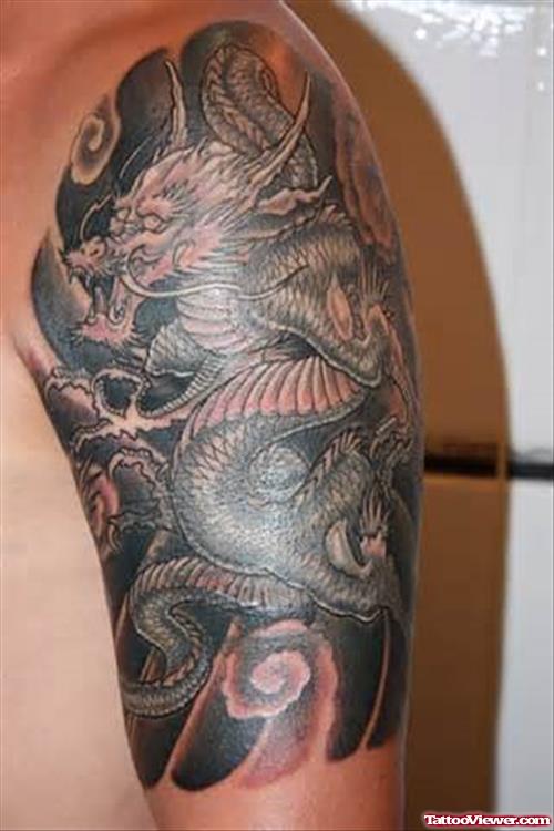 Tribal And Black Ink Dragon Tattoo On Left Half Sleeve