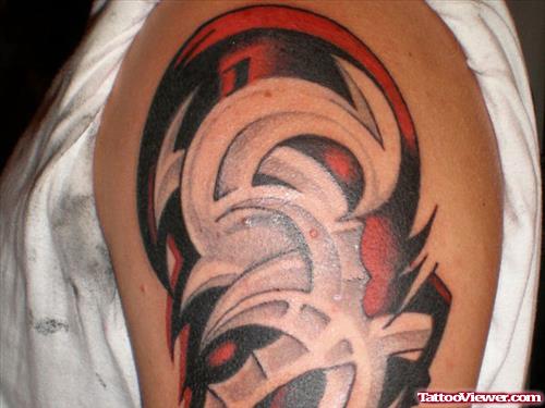 Red And Black Ink Tribal Tattoo On Shoulder