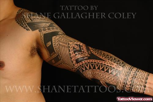 Black Ink Tribal Tattoo On Man Left Sleeve