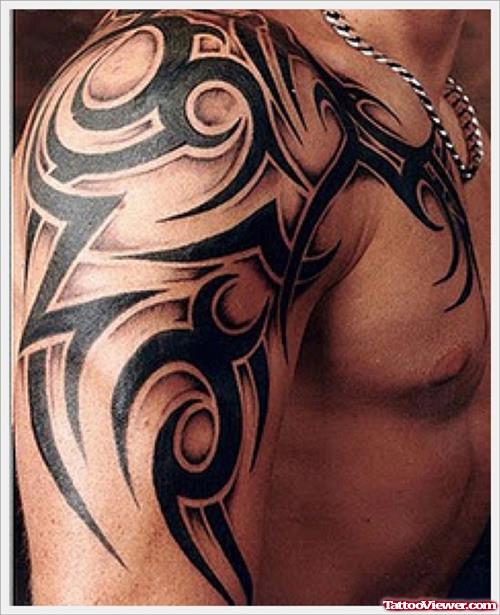 Black Ink Tribal Tattoo On Half Sleeve And Chest