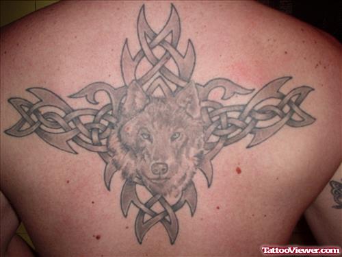 Grey Ink Tribal And Wolf Head Tattoo On Back
