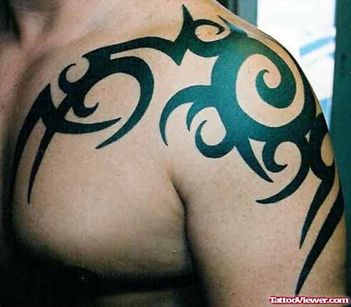Amazing Black Ink Tribal Tattoo On Left Shoulder
