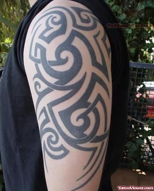 Tribal Tattoo On Left Bicep For Men