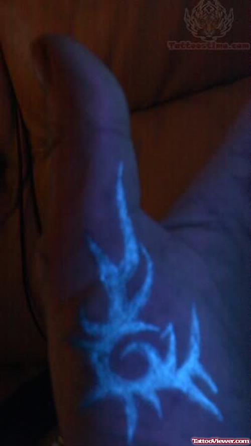 Black Light Tribal Tattoo On Hand
