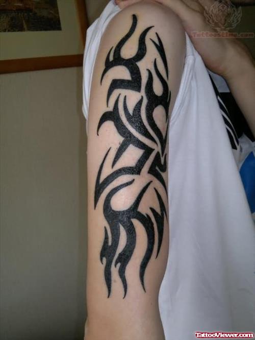 Black ink Tribal Tattoo On Biceps