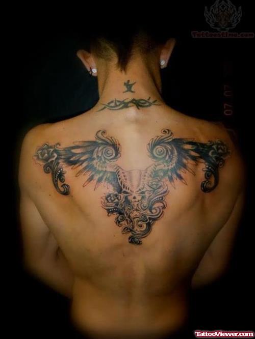 Tribal And Feather Head Tattoo On Back