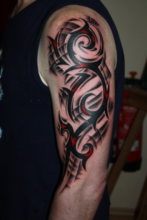 Red And Black Ink Tribal Tattoo On Left Half Sleeve