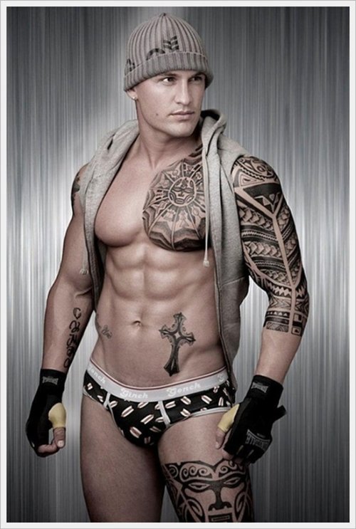 Black Ink Tribal Tattoo On Man Chest And Left Sleeve