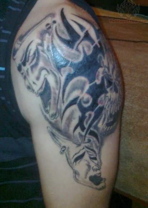 Clown And Tribal Tattoo On Left Shoulder