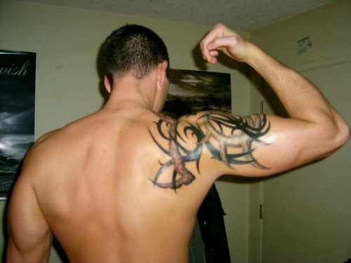 Black Ink Tribal Tattoo On Man Shoulder