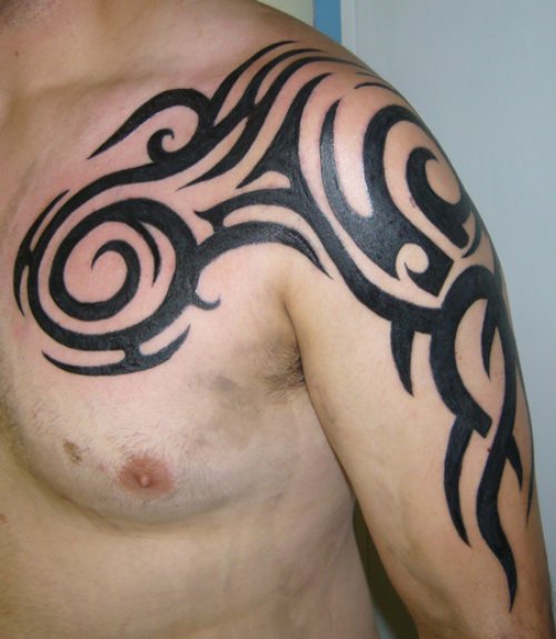 Black Ink Tribal Chest And Left Shoulder Tattoo