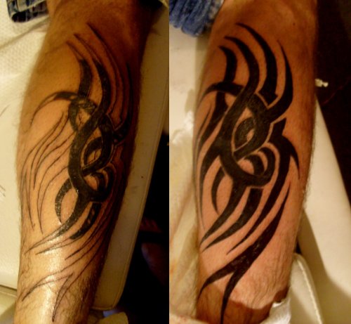Amazing Black Ink Tribal Tattoo On Arm For Men