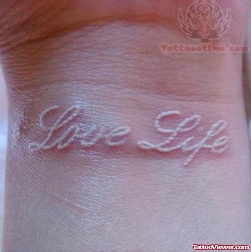 Love Life White Ink Tattoo On Wrist