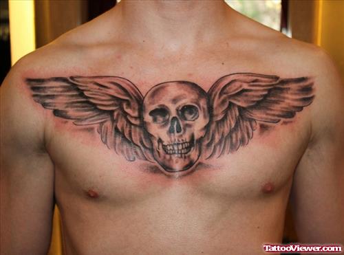 Grey Ink Winged Skull Tattoo On Man Chest