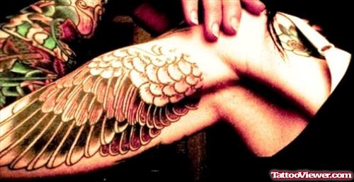 Amazing Colored Wing Tattoo On Bicep