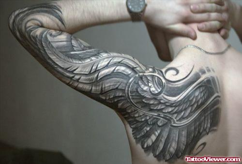 Grey Ink Wing Tattoo On Man Left Sleeve