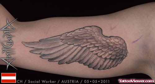 Grey Ink Wing Tattoo On Biceps