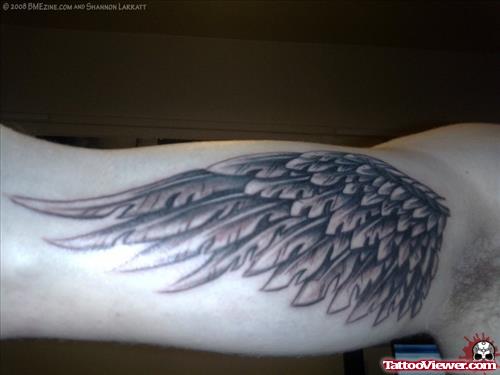 Grey Ink Angel Wing Tattoo On Bicep