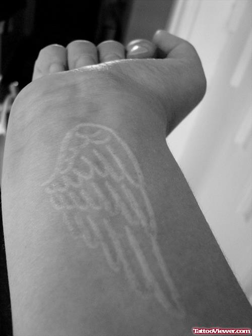 White Ink Angel Wing Tattoo On Wrist