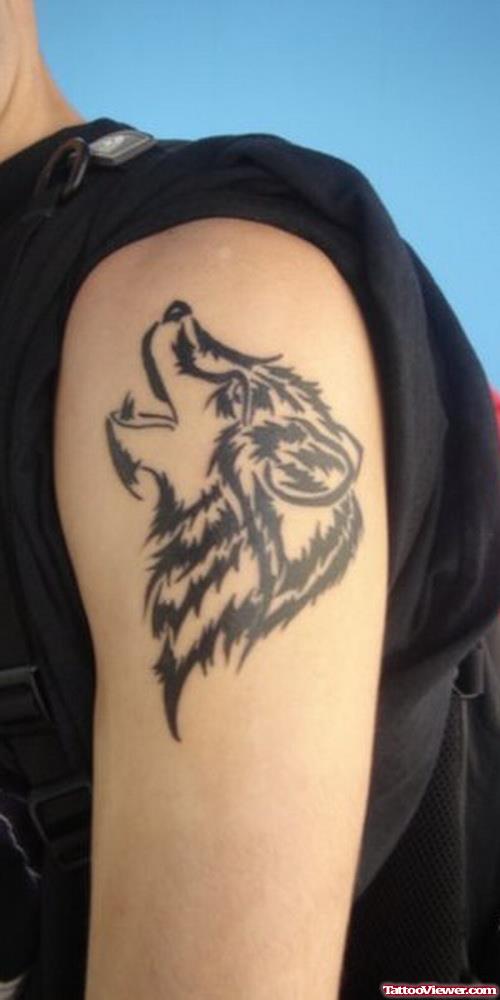Tribal Howling Wolf Head Tattoo On Left Bicep