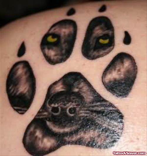 Yellow Eyes Wolf Image In Paw Tattoo