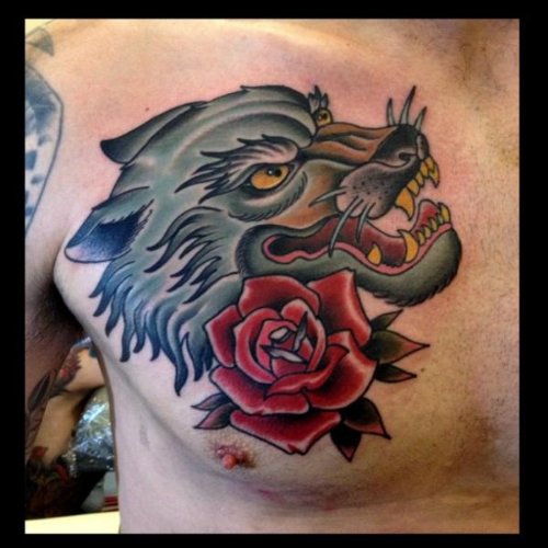 Red Rose And Wolf Head Tattoo On Man Chest