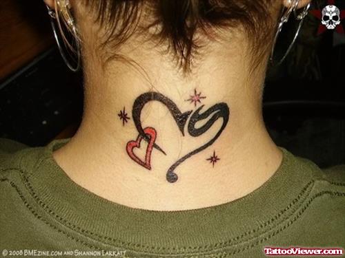 Red Heart And Black Tribal Tattoo On Back For Women