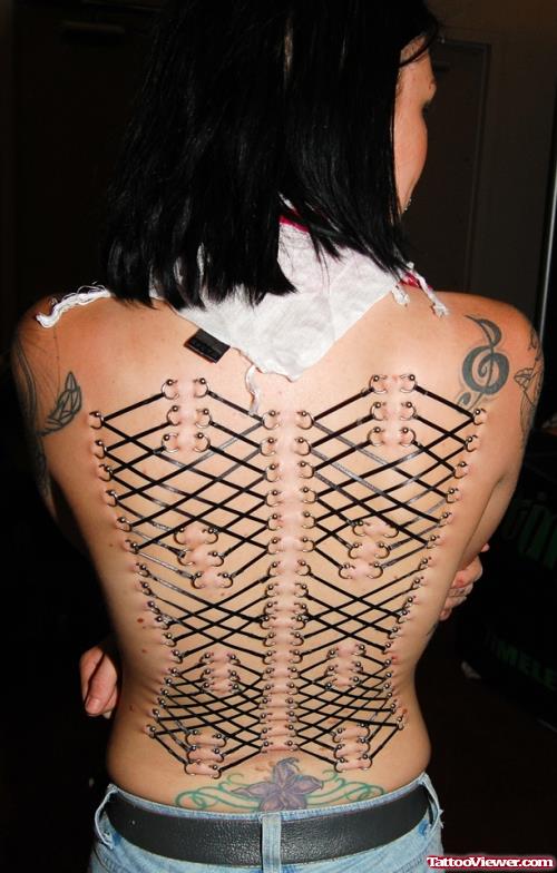 Corset And Violen Key Women Tattoo On Back