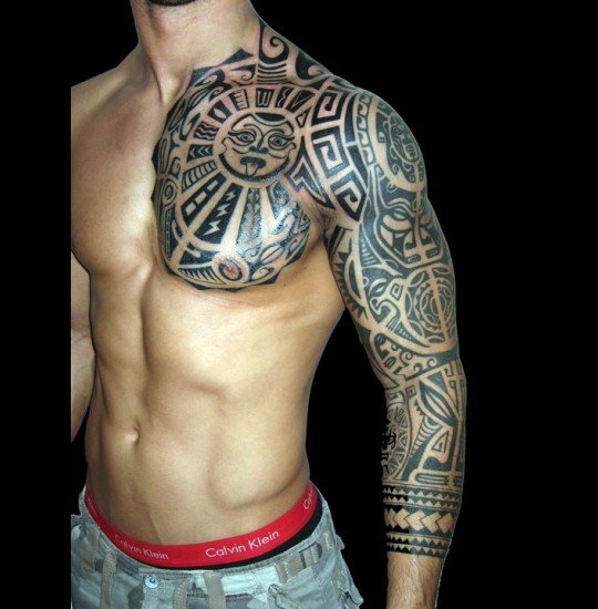 Maori Tattoo On Man Chest And Left Sleeve